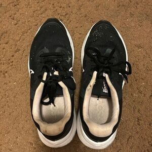 Black Nike tennis shoes with pink